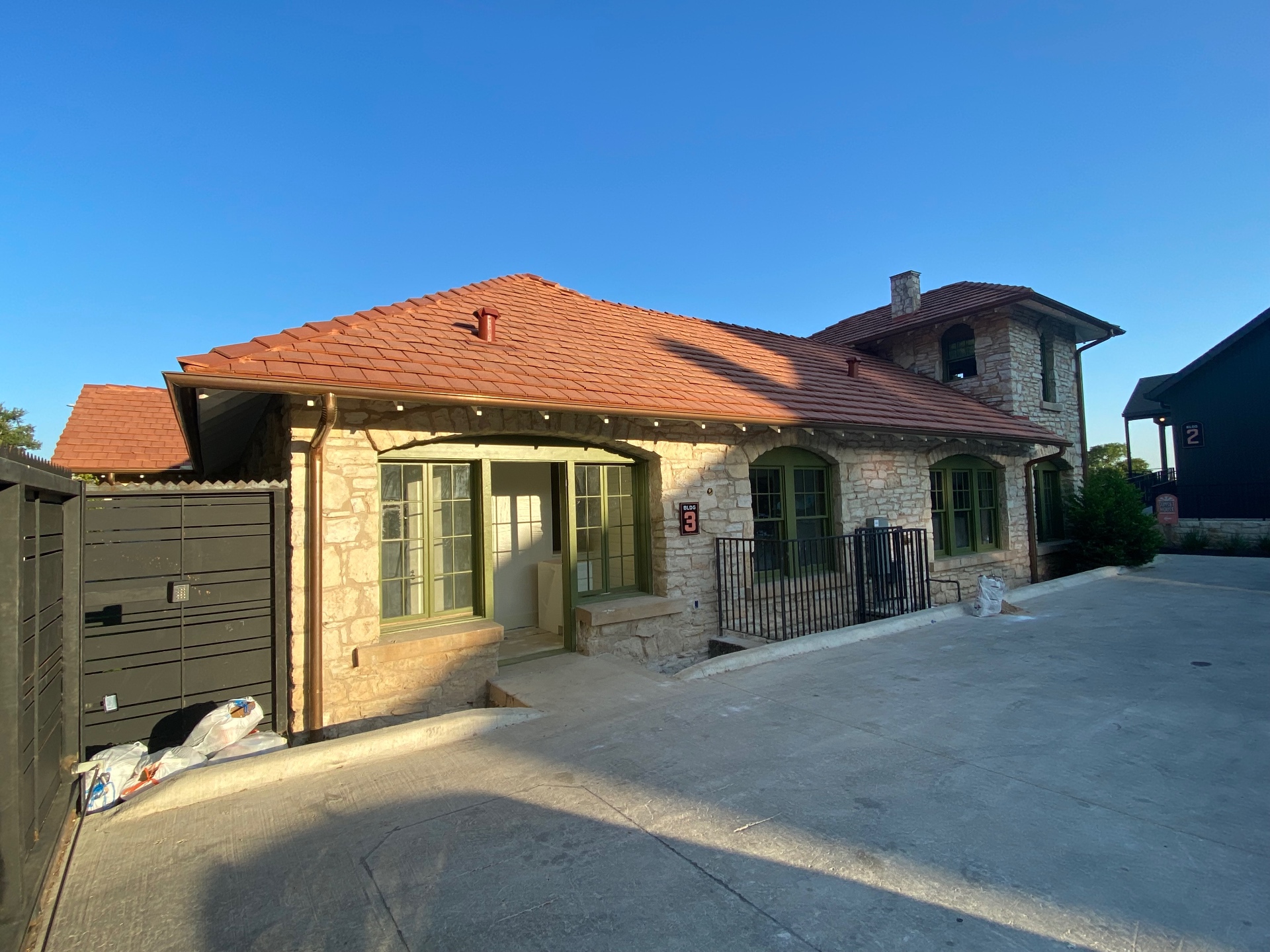 Stone home we painted with fresh green window trim and doors