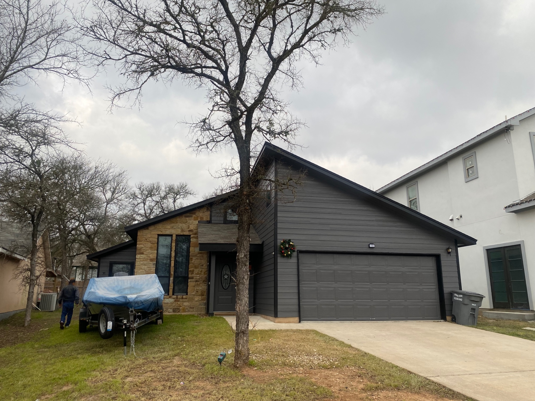 Central Texas home exterior repainted in deep charcoal by JJY Painting