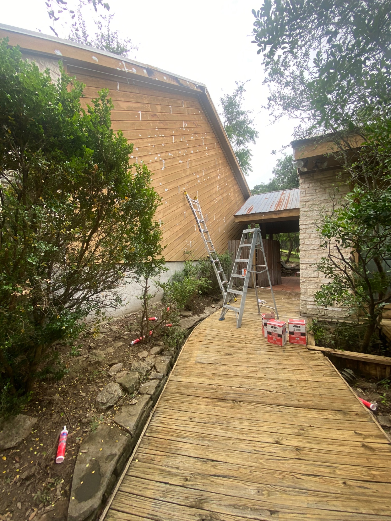 Exterior wood siding undergoing detailed patching and repair before painting