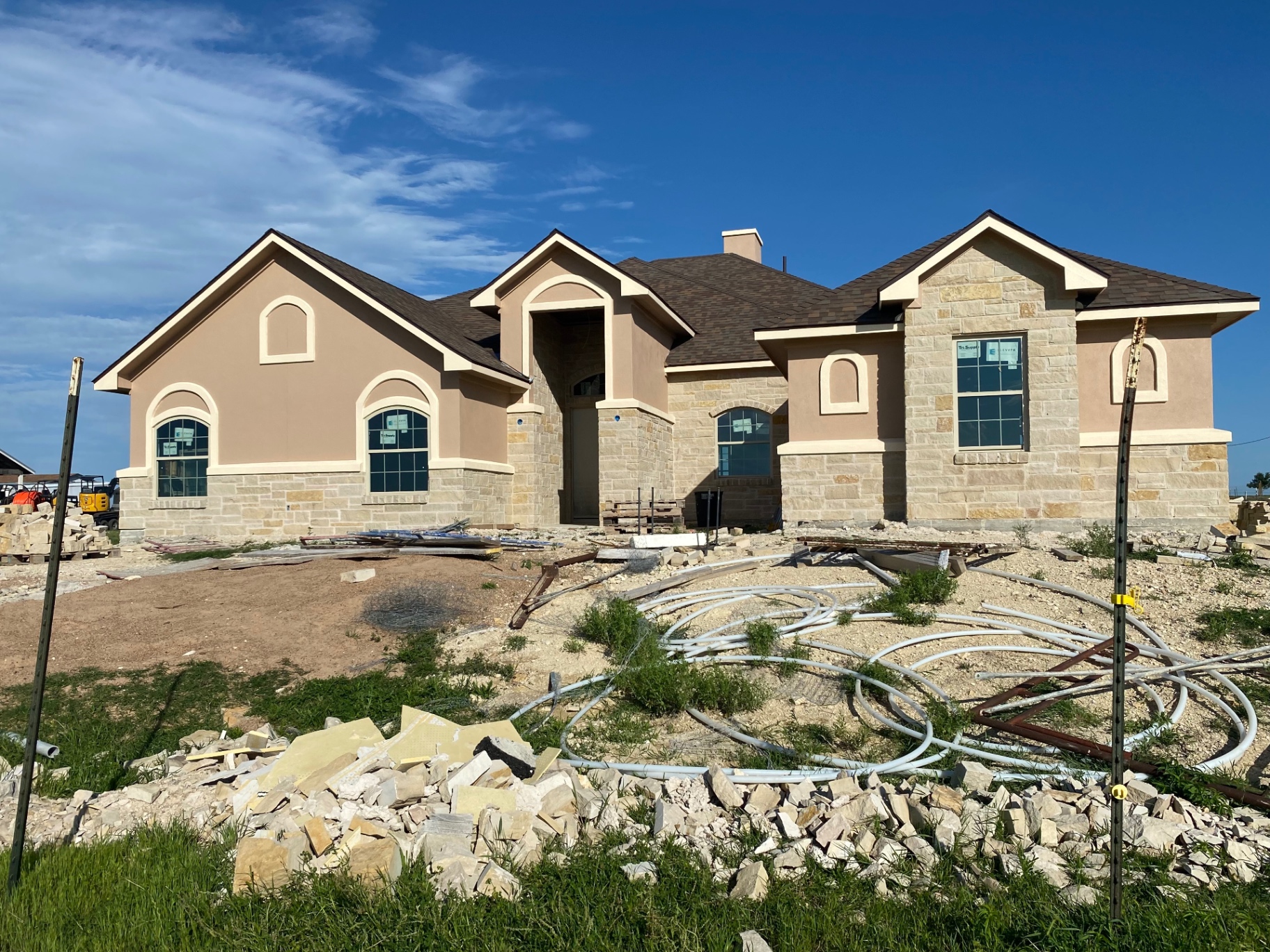 New custom home we painted with stucco, stone, and cream trim